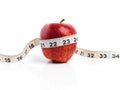 Apple, wellness and tape measure with red fruit in studio isolated on white background for diet, health or nutrition Royalty Free Stock Photo