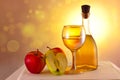 Apple wine  cider in a glass and in a bottle and ripe apples on the table. Royalty Free Stock Photo