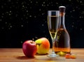 Apple wine in a glass and in a bottle and ripe apples on the table. Royalty Free Stock Photo