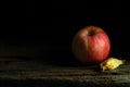 Apple on wood plate with moody and dark style and background Royalty Free Stock Photo