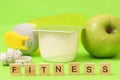 apple, yogurt and centimeter tape on green background. Royalty Free Stock Photo