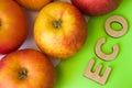 Apples as ECO food. Apples are on white background with text eco of wooden letters on green. Example of sustainable environmentall Royalty Free Stock Photo