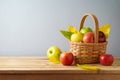 Apples in basket on wooden table. Autumn and fall harvest background Royalty Free Stock Photo