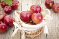 Apples in a basket on a wooden table Royalty Free Stock Photo