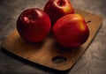 Apples board. Apples are on a cutting board with a dark background