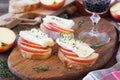 Apples and Camembert cheese bread toasts and glass of red wine Royalty Free Stock Photo
