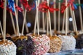 Apples in caramel and sprinkles. Sweet delicious dessert on a stick Royalty Free Stock Photo