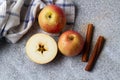 Apples and cinnamon on a gray background