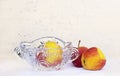 apples crystal vase and casting water on a white background Royalty Free Stock Photo
