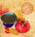 Apples, cut red pomegranate and honey on the old paper texture. Jewish New Year Rosh Hashanah symbols. Shana Tova round stamp