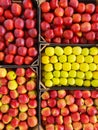 Apples of different varieties lie in a wicker box on a grocery shelf. Close-up of fruit in a supermarket. Fresh apples on the Royalty Free Stock Photo