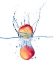 Apples falling under water with a splash on white