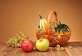 Apples, grapes and decorative pumpkins in wicker baskets