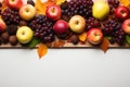 Apples, grapes, nuts and autumn leaves on top of a white background. Banner for Thanksgiving Day Royalty Free Stock Photo