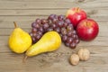 Apples grapes and pears, wooden table Royalty Free Stock Photo