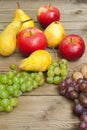 Apples grapes and pears, wooden table Royalty Free Stock Photo