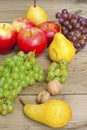 Apples grapes and pears, wooden table Royalty Free Stock Photo