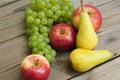 Apples grapes and pears, wooden table Royalty Free Stock Photo