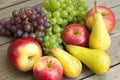 Apples grapes and pears, wooden table Royalty Free Stock Photo