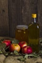 Apples with a jar of honey and a bottle of olive oil Royalty Free Stock Photo