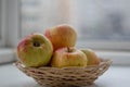 Apples lie in a wicker basket close-up