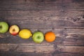 Apples orange and lemon on the wooden table