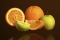 Apples and oranges fruits with drops and splashes of water on a black background Royalty Free Stock Photo