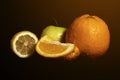 Apples and oranges fruits with drops and splashes of water on a black background Royalty Free Stock Photo