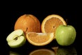 Apples and oranges fruits with drops and splashes of water on a black background Royalty Free Stock Photo