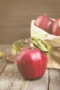 Apples in paper package on a dark wooden background. Toned Royalty Free Stock Photo