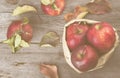 Apples in paper package on a dark wooden background. Top view, c Royalty Free Stock Photo