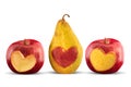 Apples and pear with heart shape carved out on white background Royalty Free Stock Photo