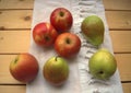 Apples and pears on the kitchen towel on a wooden table, rustic styl