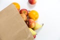 Apples and pears in a paper bag of craft paper on white background Royalty Free Stock Photo