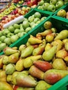 Apples and pears in plastic boxes in a store, close-up Royalty Free Stock Photo