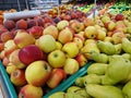 Apples and pears in plastic boxes in a store, close-up Royalty Free Stock Photo