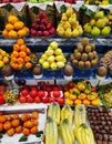 Apples, pears, pomegranates, bananas, oranges, grapes, kiwis, persimmons and other fruits on display at the market Royalty Free Stock Photo