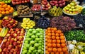 Apples, pears, pomegranates, bananas, oranges, grapes, kiwis, persimmons and other fruits on display at the market Royalty Free Stock Photo