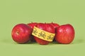 Apples with poison skull symbol sticker on green background. Concept of pesticide residues