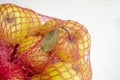 Apples in the shopping net. In the red grid are yellow apples. Mesh with apples on a white background. A ECO grid for Royalty Free Stock Photo