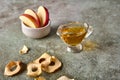 Apples slices in bowl, chips and juice on wooden background