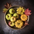 Apples and small pumpkins in an old rustic bowl Royalty Free Stock Photo