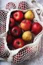 Apples starking in the mesh bag Royalty Free Stock Photo