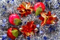 Apples and stars on a blue and silvery tinsel