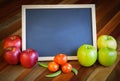 Apples, tomatoes, sunflower and blackboard composition