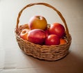 Apples and tomatoes are in a wicker basket Royalty Free Stock Photo