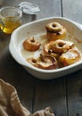 Apples topped nuts honey cinnamon round baking pan wooden table Royalty Free Stock Photo