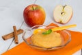 Applesauce with cinnamon and orange spoon