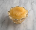 Applesauce in a glass bowl atop a marble table Royalty Free Stock Photo