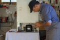 Appliance service technician in his workshop repairing a faulty refrigerator. Technician at work Royalty Free Stock Photo